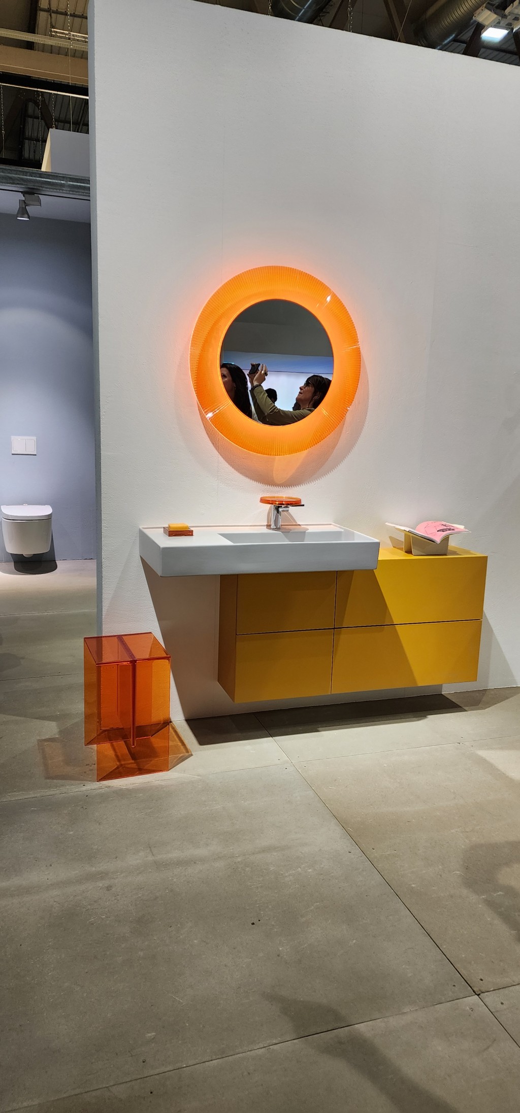 A yellow and orange bathroom display at Salone Internazionale del Mobile di Milano
